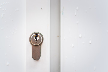 A key hole on the while door - closeup