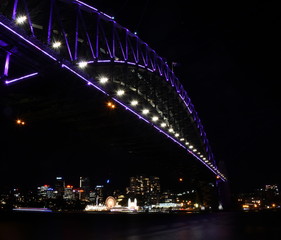 Fototapeta na wymiar Sydney, Australia - May 27, 2019. Harbour Bridge and Luna Park illuminated with colourful light design imagery during the Vivid Sydney 2019 free annual public event.