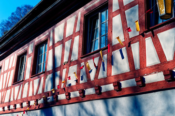 Old mill with half-timbered house next to a city wall on Lake Constance