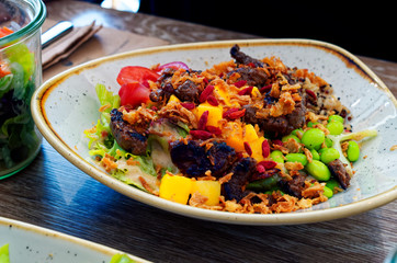 Vegetable Bowl in a restaurant made of healthy ingredients Meat and salad with fresh vegetables and rice