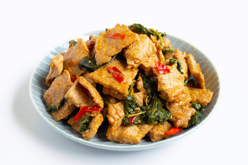 Stir-fried hot and spicy pork with basil on white