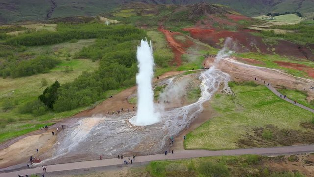 Flying above Strokkur geysir in the moment of eruption, Iceland, 4k aerial drone view