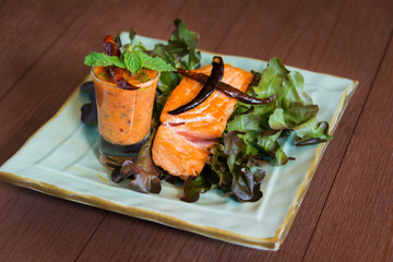 Roasted salmon steak with hot and spicy seasoning sauce Thai style and fresh vegetable delicious food for healthy on wooden table