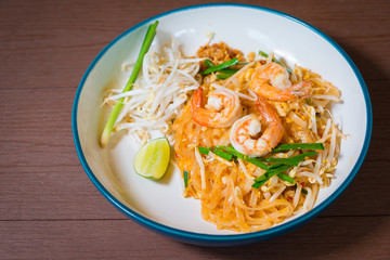 Pad Thai delicious stir fried is popular noodle food Thai traditional Style the favorite famous street food is Thailand national dishes on wooden table