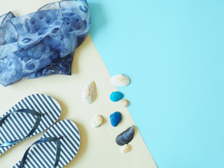 Concept of summer holidays with beach elements on a beige and blue background. The view from the top.Flat lay