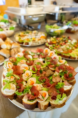 Beautifully decorated catering banquet table with different food snacks and appetizers