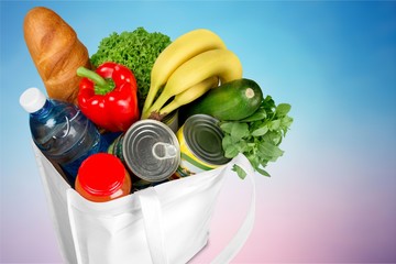 Full white shopping bag on bronw wooden background