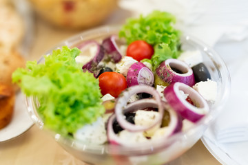Salad with lettuce, onion, cherry tomato, olives, feta cheese and olives.
