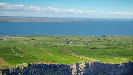 Fototapeta na wymiar The green lands at the Cliffs of Moher in Ireland - travel photography