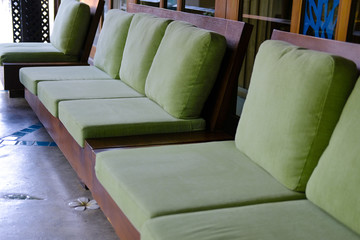 green cushion on wooden sofa chair. living design for home