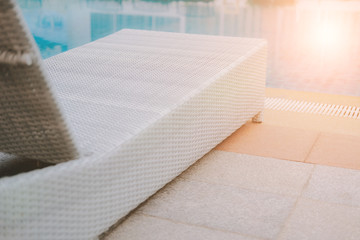 Fototapeta na wymiar wicker rattan pool sun bed deckchair at swimming pool