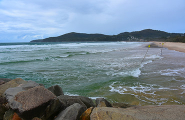 Noosa main beach on a cloudy day - a famous tourist destination on Sunshine Coast  (Queensland, Australia).