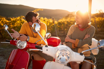 Romantic couple riding on a scooter in European and enjoying on vacation..