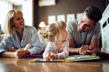 Cute child with dad and mom playing