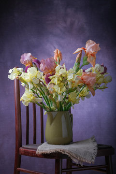 A bouquet of irises in a vase on the table.
