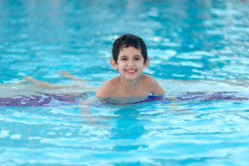 Fototapeta na wymiar Boy is in the swimming pool 