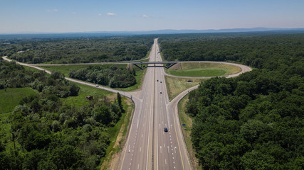 Aerial view of highway cloverleaf interchange seen from above.