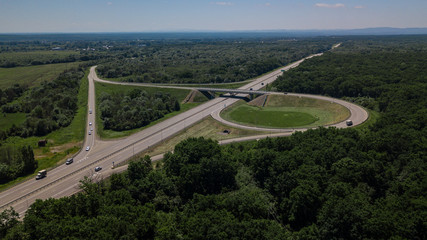 Aerial view of highway cloverleaf interchange seen from above.