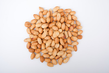 Top view of roasted peanuts, heap or group of peanuts isolated on white background, top view