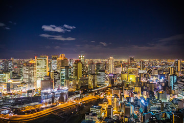 Aerial view of the Osaka cityscape at night from the observation platform at the Umeda sky building.
