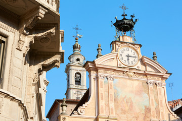 Fototapeta na wymiar MONDOVI, ITALY - AUGUST 15, 2016: Saint Peter and Paul church clock and bell tower with automaton in a sunny summer day, blue sky in Mondovi, Italy.