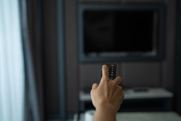 hand holding remote control television