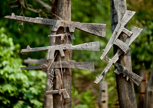 Wood kalshnikovs at akha village entrance, Ban ta mi, Laos
