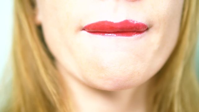Close-up. sexy lips of a beautiful woman with beautiful red makeup, licks her lips