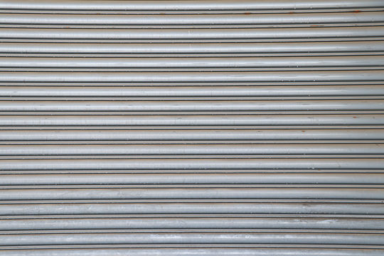 Rolling steel door background. Steel rolling door surface. - Powered by Adobe