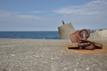 Rusty padlock on the breakwater in Poland.