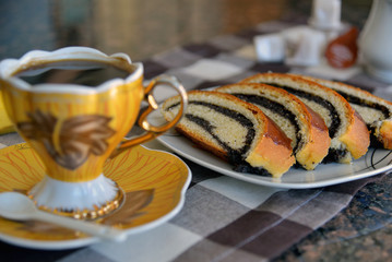 Turkish coffe in antique coffe cup with poppy seed rolls