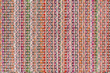 Fototapeta premium Multicolored knitted fabric background texture. Сolorful red fabric with a pattern. Fragment colored wool carpet, bright wicker colorful rug