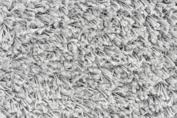 White natural fleece carpet texture background. Wool fabric texture fragment shaggy mat