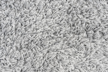 White natural fleece carpet texture background. Wool fabric texture fragment shaggy mat