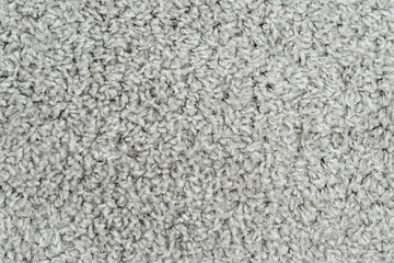 White natural fleece carpet texture background. Wool fabric texture fragment shaggy mat