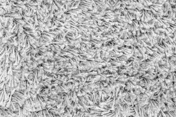 White natural fleece carpet texture background. Wool fabric texture fragment shaggy mat