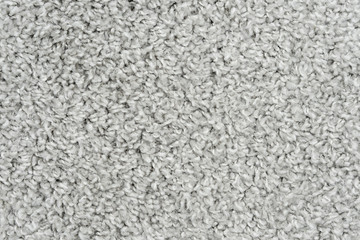White natural fleece carpet texture background. Wool fabric texture fragment shaggy mat
