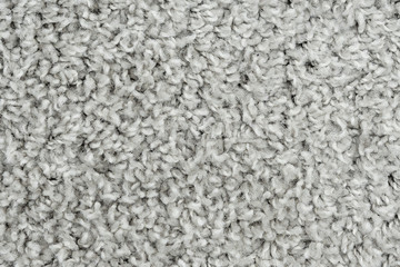 White natural fleece carpet texture background. Wool fabric texture fragment shaggy mat