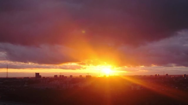 Amazing sunset over city, close up on modern downtown Novosibirsk skyline buildings. Time lapse