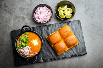 Indian spicy fast food / snacks Pav Bhaji with bread, onion and butter