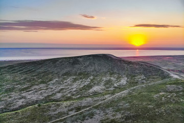 Beautiful landscape with sunset over saline lake Baskunchak