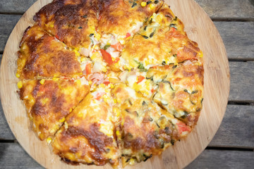 Custom made pizzas at home on appetizing brown wooden trays