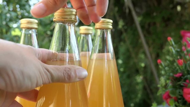 Opening a apple juice bottle.