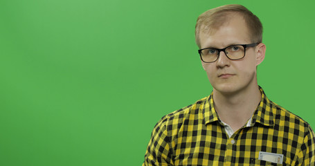 Caucasian man in yellow shirt and glasses. Place for your logo or text