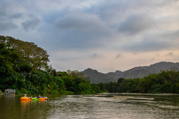 local people swimming in a river in the rainforest of south america