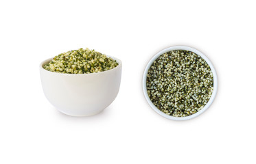 Hemp seeds isolated on white. Bowl with hemp seeds isolated on white background. Peeled raw hemp seeds in bowl. Top view.