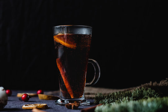 A glass of mulled wine with oranges and spices