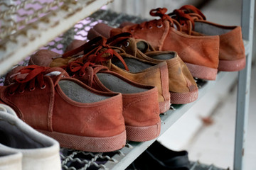 Student shoes in Thailand placed on the steel floor.