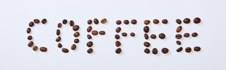 panoramic shot of coffee lettering made of coffee beans on white background