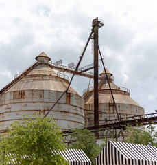 Two rusty round silos on a cloudy day © Sebastian